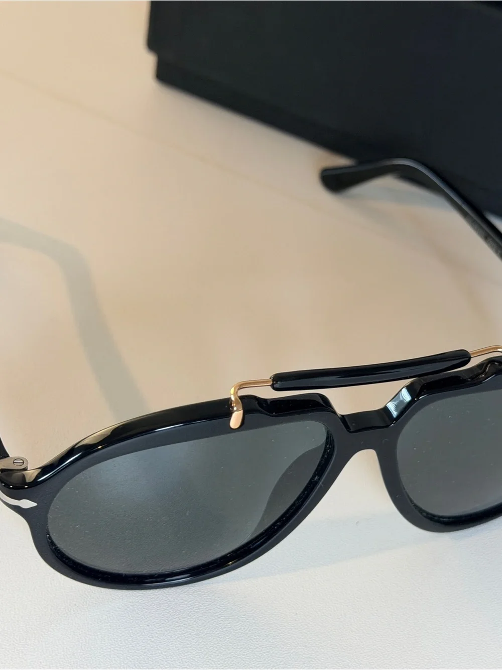 Persol Polarized Sienna Black Sunglasses with Gold Accents and Dark Lenses